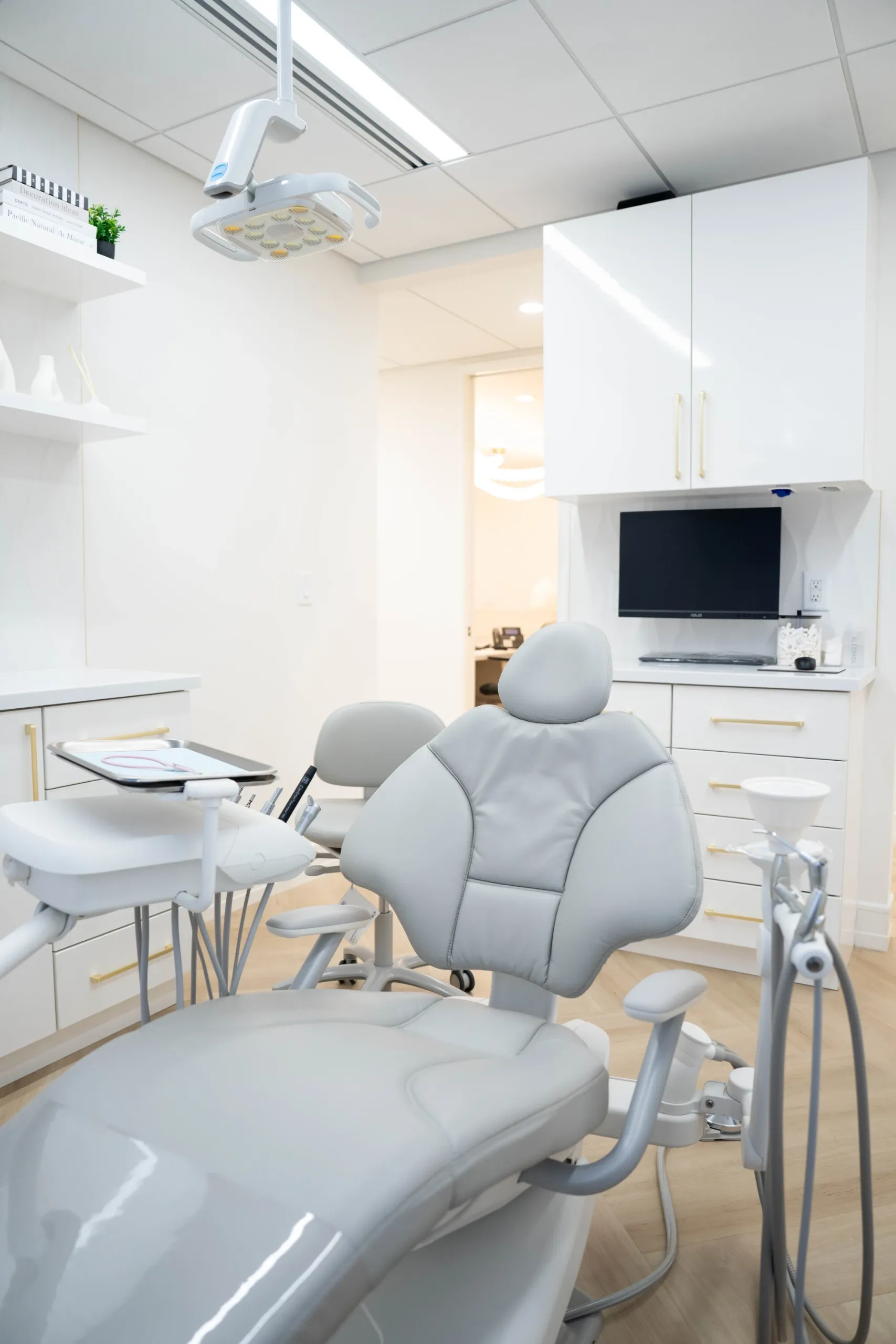 Dental treatment room with a chair and overhead light at Starik Dental Studio